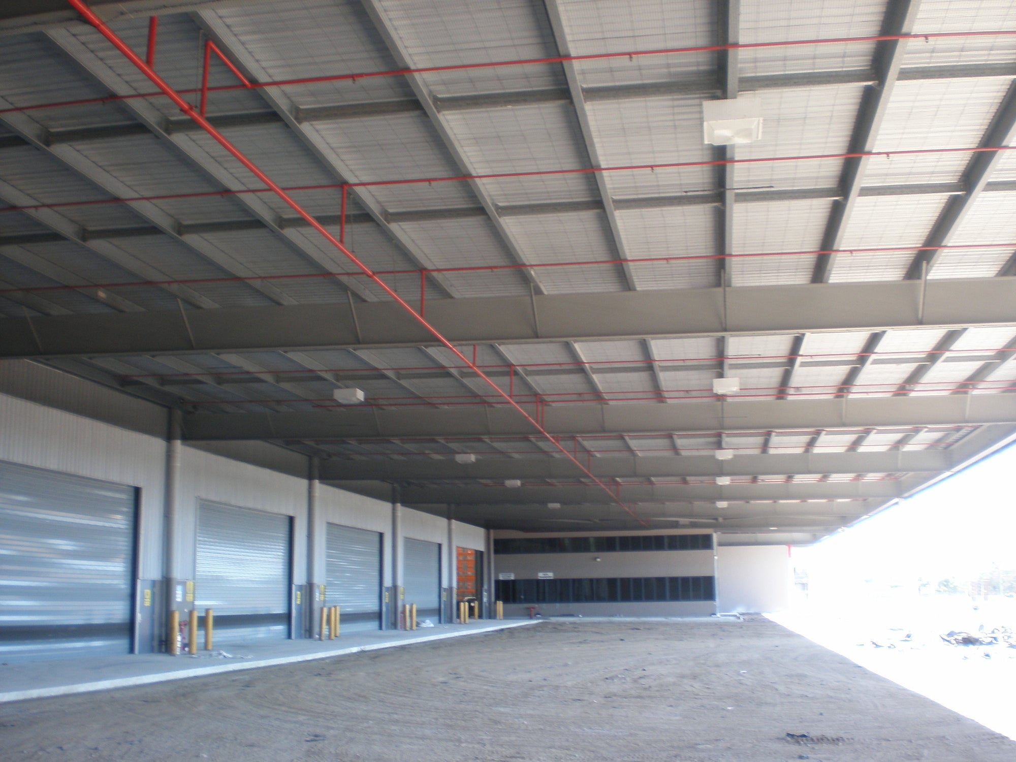 Bird Management Course, module 1: session 02, the steel portal roof over a distribution centre dispatch dock.
