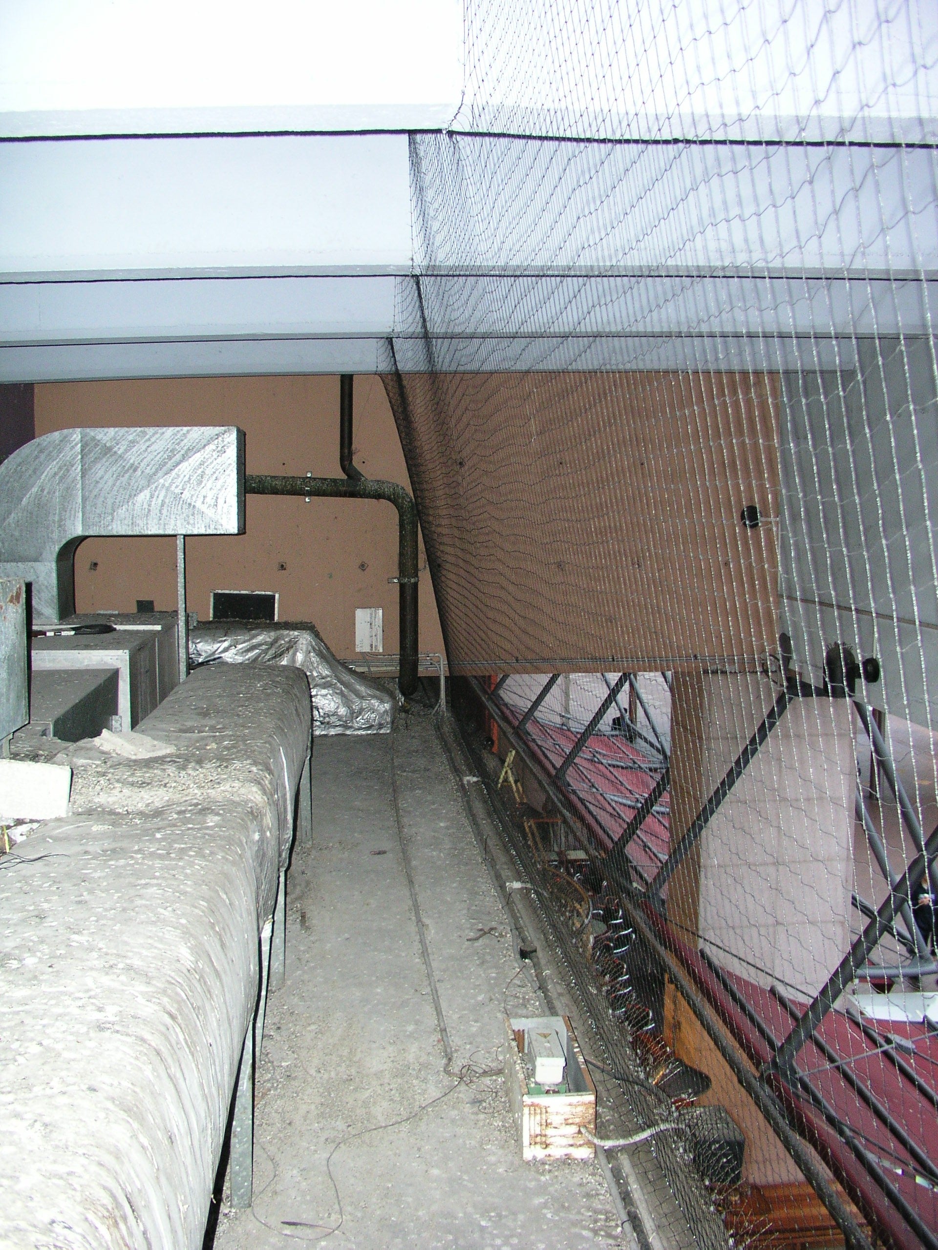 Bird Management Course, module 1: session 02, bird netting installed to close off a roof void above industrial ductwork.