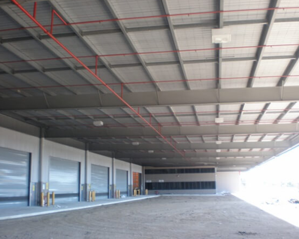 Completed bird netting under the roof steel of a distribution centre loading dock, the roof void closed off. Bird Management Course, session 03.